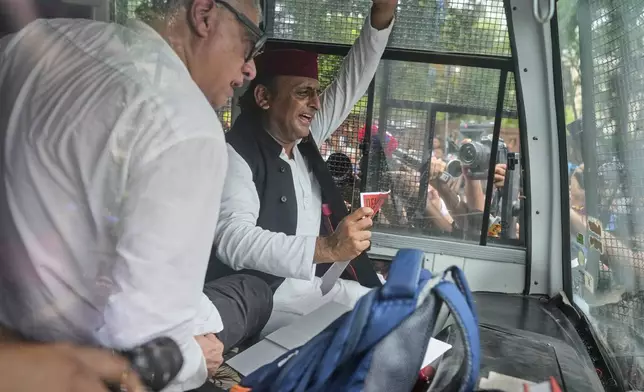 Samajwadi Party lawmaker Akhilesh Yadav waves as he is detained and taken away in a police van during a protest calling for the rollback of a controversial revision of the voter list in one of the country’s poorest states where key elections are scheduled in November, in New Delhi, India, Monday, Aug. 11, 2025. (AP Photo/Manish Swarup)