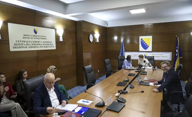 Members of the Central Election Commission of Bosnia and Herzegovina, prepare for a session discussing the potential removal of separatist Bosnian Serb leader Milorad Dodik from his position as president of the Serb entity in Bosnia, following an appeals court verdict, in Sarajevo, Bosnia, Wednesday, Aug. 6, 2025. (AP Photo/Armin Durgut)