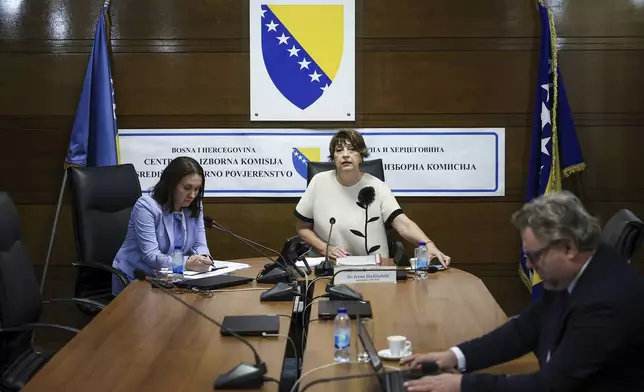 Members of the Central Election Commission of Bosnia and Herzegovina, prepare for a session discussing the potential removal of separatist Bosnian Serb leader Milorad Dodik from his position as president of the Serb entity in Bosnia, following an appeals court verdict that sentenced him to one year in jail and imposed a six-year ban on all political activities, in Sarajevo, Bosnia, Wednesday, Aug. 6, 2025. (AP Photo/Armin Durgut)