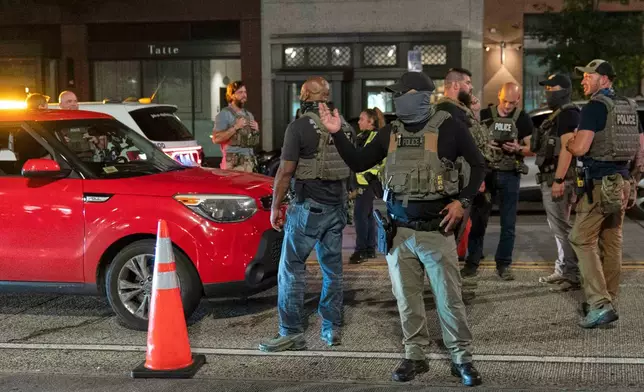 Department of Homeland Security Investigations agents join Washington Metropolitan Police Department officers as they conduct traffic checks at a checkpoint along 14th Street in northwest Washington, Wednesday, Aug. 13, 2025, in Washington. (AP Photo/Jose Luis Magana)