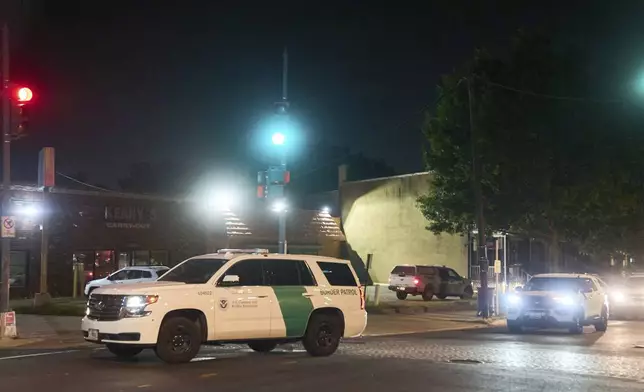 Agents with U.S. Customs and Border Protection as well as Metropolitan Police leave the parking lot of Kenny's Carry-Out and drive in a caravan along Kennedy Street NW, in the early morning of Wednesday, Aug. 13, 2025, in northwest Washington. (AP Photo/Jacquelyn Martin)