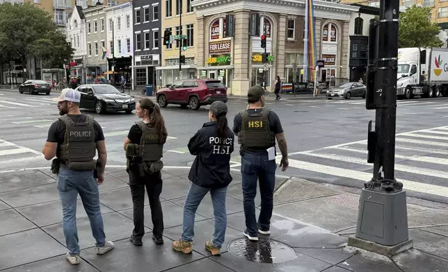 Department of Homeland Security Investigation officers pause at the intersection of 14th and U Streets in northwest Washington, while on patrol Wednesday, Aug. 13, 2025. (AP Photo/Pablo Martinez Monsivais)