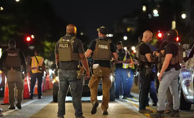 Department of Homeland Security Investigations agents join Washington Metropolitan Police Department officers as they conduct traffic checks at a checkpoint along 14th Street in northwest Washington, Wednesday, Aug. 13, 2025, in Washington. (AP Photo/Alex Brandon)