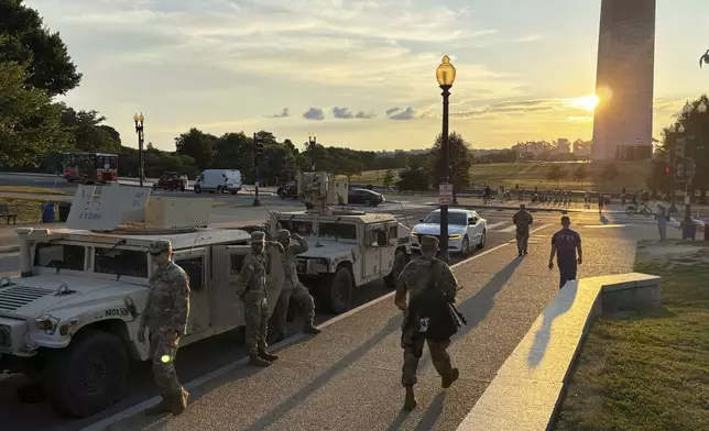 District of Columbia National Guard members park near the Washington Monument Tuesday, Aug. 12, 2025, in Washington. (Kyle Cooper/WTOP News via AP)