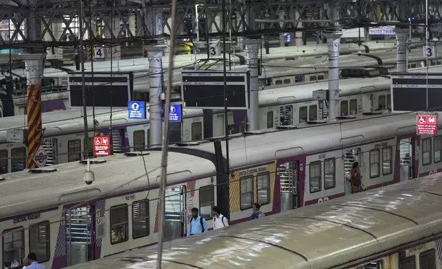 Halted local trains at Chhatrapati Shivaji Maharaj Terminus after heavy rains disrupted rail services in Mumbai, Tuesday, Aug. 19, 2025. (AP Photo/Rajanish Kakade)