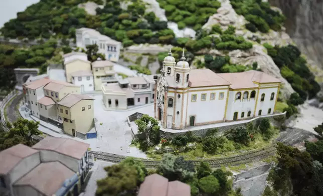 Miniature homes and a church are made to look like Ouro Preto, Brazil, at a workshop in Pilar, Argentina, Wednesday, June 25, 2025. (AP Photo/Natacha Pisarenko)