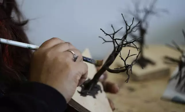 A miniature tree is painted in Pilar, Argentina, Wednesday, June 25, 2025. (AP Photo/Natacha Pisarenko)