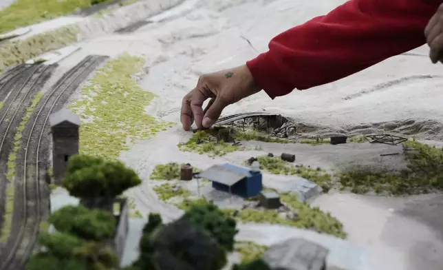 A miniature version of Mairinque, Brazil, is worked on at a workshop in Pilar, Argentina, Wednesday, June 25, 2025. (AP Photo/Natacha Pisarenko)