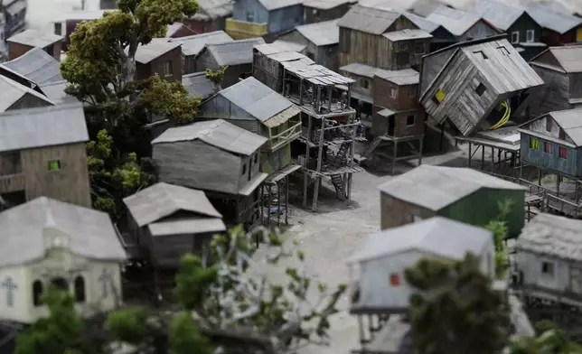 Miniature homes at a workshop in Pilar, Argentina, Wednesday, June 25, 2025, are assembled to look like Manaus, Brazil. (AP Photo/Natacha Pisarenko)