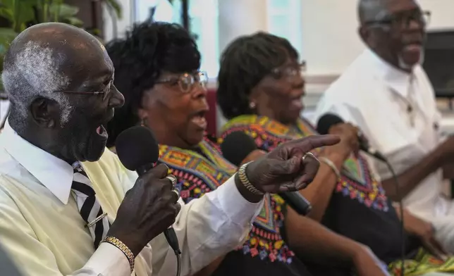 "Voices of Gullah" members, Joe Murray, from left, Minnie "Gracie" Gadson, Rosa Murray and Charles "Jojo" Brown, sing Gullah spirituals at the Brick Baptist Church in St. Helena Island, Saturday, July 19, 2025. (AP Photo/Luis Andres Henao)