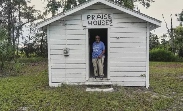 James Peter Smalls, a deacon, who takes care of the Mary Jenkins Praise House, poses for a photo outside the wooden structure in St. Helena Island, Sunday, July 20, 2025. (AP Photo/Luis Andres Henao)