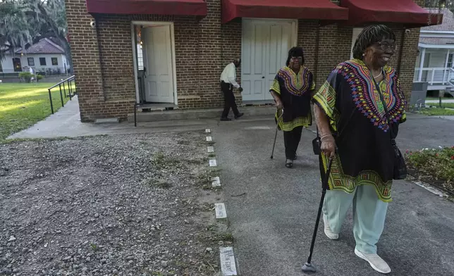 "Voices of Gullah" members, Rosa Murray, from right, Minnie "Gracie" Gadson and Joe Murray walk out of the Brick Baptist Church after a concert, in St. Helena Island, Saturday, July 19, 2025. (AP Photo/Luis Andres Henao)