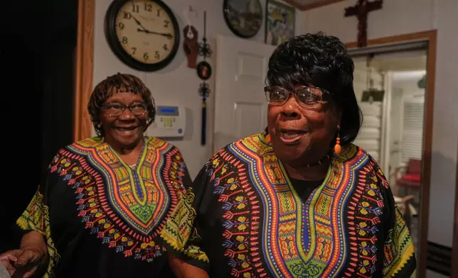 "Voices of Gullah" singers, Rosa Murray, left, and Minnie "Gracie" Gadson share a laugh at Murray's home in St. Helena Island, Saturday, July 19, 2025. (AP Photo/Luis Andres Henao)
