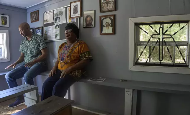 "Voices of Gullah" singer Minnie "Gracie" Gadson sings a Gullah spiritual while musicologist Eric Crawford follows along patting his thighs in body percussion, at the Coffin Point Praise House in St. Helena Island, Sunday, July 20, 2025. (AP Photo/Luis Andres Henao)