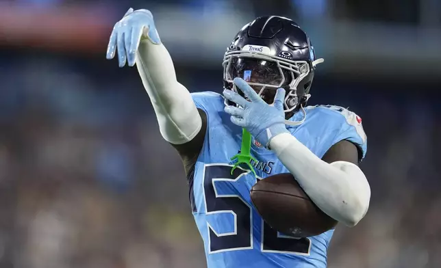 Tennessee Titans linebacker James Williams Sr. (52) celebrates after an interception against the Minnesota Vikings during the first half of a preseason NFL football game, Friday, Aug. 22, 2025, in Nashville, Tenn. (AP Photo/George Walker IV)