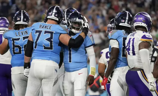 Tennessee Titans quarterback Cam Ward (1) celebrates with guard Blake Hance (73) after a touchdown by running back Julius Chestnut (36) during the first half of a preseason NFL football game against the Minnesota Vikings, Friday, Aug. 22, 2025, in Nashville, Tenn. (AP Photo/George Walker IV)