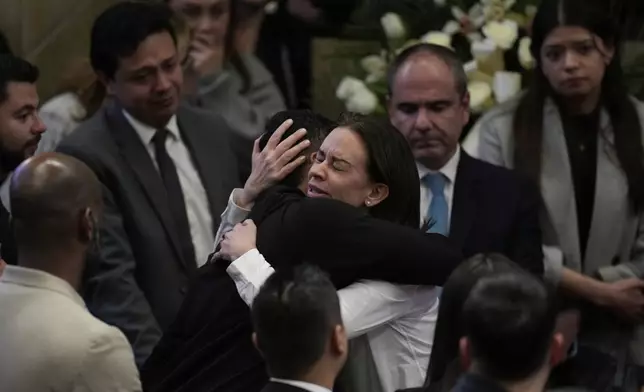 Claudia Tarazona, the wife of opposition Sen. and presidential hopeful Miguel Uribe, who died from wounds suffered when he was shot during a political rally, attends a ceremony honoring her husband, at Congress in Bogota, Colombia, Monday, Aug. 11, 2025. (AP Photo/Fernando Vergara)