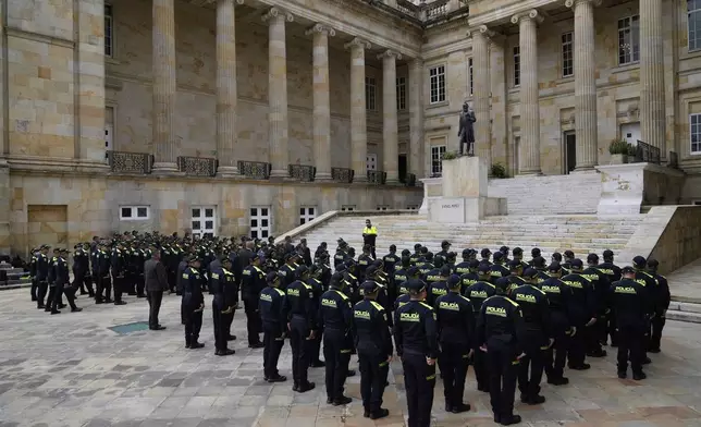 Police line up for a roll call at Congress in Bogota, Colombia, after the announcement of the death of opposition Sen. Miguel Uribe, more than two months after he was shot during a campaign rally, Monday, Aug. 11, 2025. (AP Photo/Fernando Vergara)