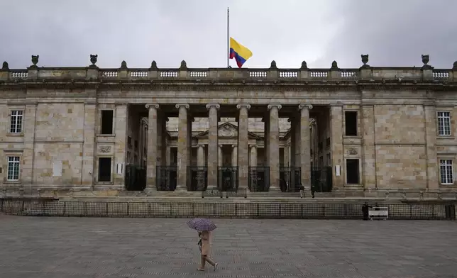 The flag flies at half-staff at Congress in Bogota, Colombia, after the announcement of the death of opposition Sen. Miguel Uribe, more than two months after he was shot during a campaign rally, Monday, Aug. 11, 2025. (AP Photo/Fernando Vergara)