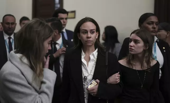 Claudia Tarazona, the wife of opposition Sen. and presidential hopeful Miguel Uribe, who died from wounds suffered when he was shot during a political rally, arrives at Congress for a ceremony honoring her husband, in Bogota, Colombia, Monday, Aug. 11, 2025. (AP Photo/Ivan Valencia)