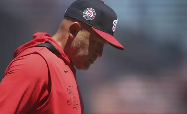 Washington Nationals interim manager Miguel Cairo looks down after making changes to the lineup during the seventh inning of a baseball game against the San Francisco Giants, Saturday, Aug. 9, 2025, in San Francisco. (AP Photo/Scott Marshall)