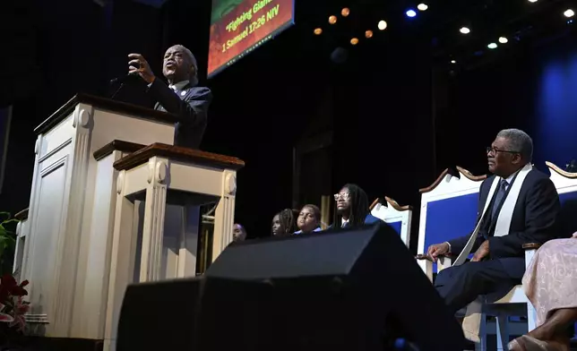 Rev. Al Sharpton delivers a sermon as Rev. Bernard L. Richardson listens at Howard University's Cramton Auditorium, Sunday, Aug. 24, 2025, in Washington, to announce a national drive in support of District of Columbia Mayor Muriel Bowser, as President Donald Trump's administration continues it's use of federal law enforcement and National Guard troops in the city. (AP Photo/John McDonnell)