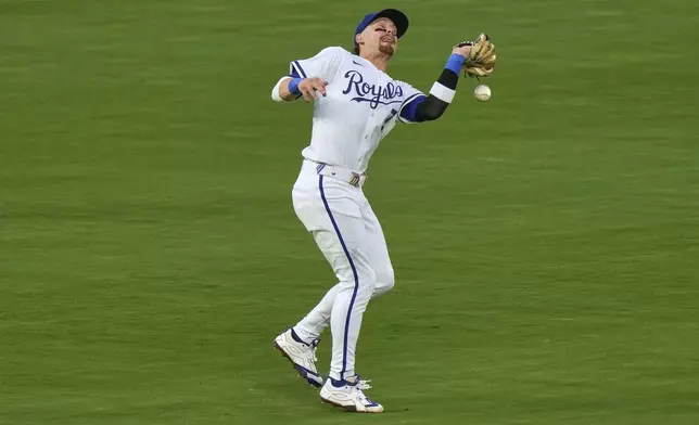 Kansas City Royals shortstop Bobby Witt Jr. can't catch a force out hit into by Washington Nationals' Paul DeJong to score one run during the sixth inning of a baseball game Tuesday, Aug. 12, 2025, in Kansas City, Mo. (AP Photo/Charlie Riedel)