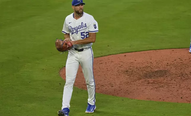 Kansas City Royals starting pitcher Michael Wacha walks to the dugout after coming out of the game during the sixth inning of a baseball game against the Washington Nationals, Tuesday, Aug. 12, 2025, in Kansas City, Mo. (AP Photo/Charlie Riedel)