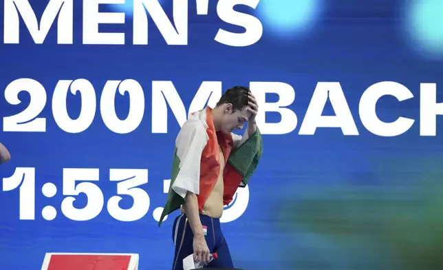 Hubert Kos of Hungary reacts after winning gold medal in the men's 200-meter backstroke final at the World Aquatics Championships in Singapore, Friday, Aug.1, 2025. (AP Photo/Vincent Thian)