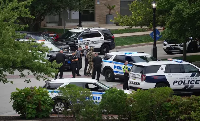 Police gather at the Villanova University campus where an active shooter was reported Thursday, Aug. 21, 2025, in Villanova, Pa. (AP Photo/Matt Slocum)