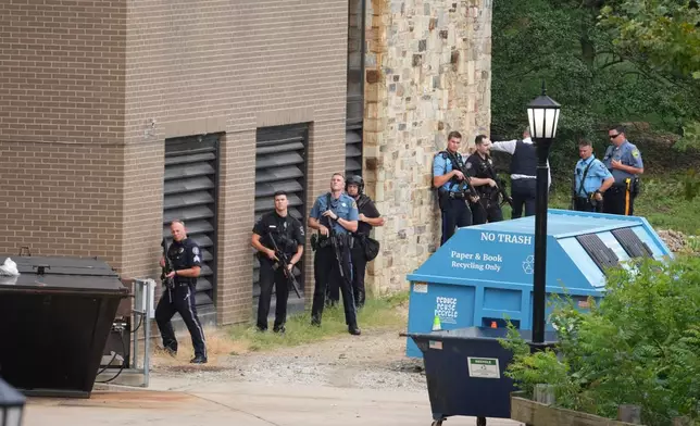 Police gather at the Villanova University campus where an active shooter was reported Thursday, Aug. 21, 2025, in Villanova, Pa. (AP Photo/Matt Slocum)