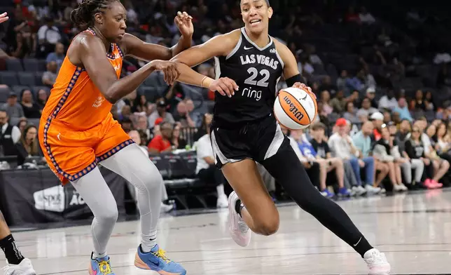 Las Vegas Aces center A'ja Wilson (22) drives against Connecticut Sun center Tina Charles, left, during the first half of a WNBA basketball game Sunday, Aug. 10, 2025, in Las Vegas. (Steve Marcus/Las Vegas Sun via AP)