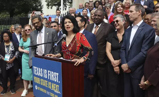 Texas State Sen. Carol Alvarado, a Democrat, speaks in a crowd of other Democratic state lawmakers outside the Massachusetts State House on Wednesday, Aug. 6, 2025 in Boston. (AP Photo/Leah Willingham)