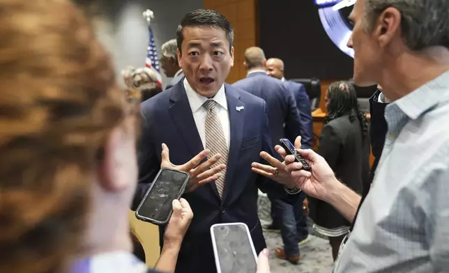 Democratic Texas Rep. Gene Wu, center, speaks with the media following a press conference with other Texas House Democrats and Democratic members of Congress at the Democratic Party in Warrenville, Ill., Monday, Aug. 4, 2025. (AP Photo/Nam Y. Huh)