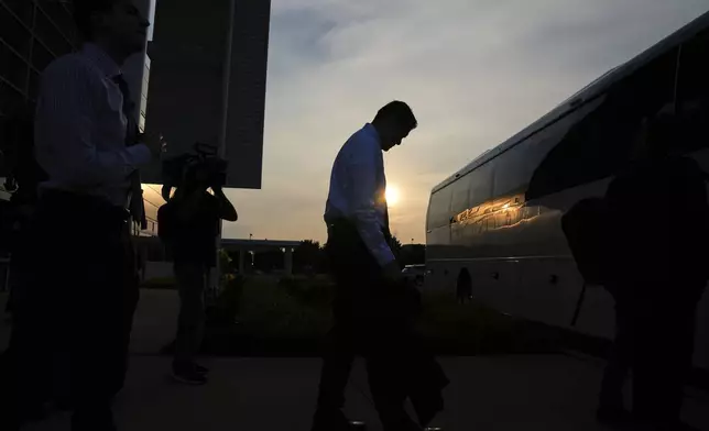 Democratic Texas Rep. Gene Wu is silhouetted by the setting sun as he boards a bus following a press conference with other Texas House Democrats and Democratic members of Congress at the Democratic Party in Warrenville, Ill., Monday, Aug. 4, 2025. (AP Photo/Nam Y. Huh)