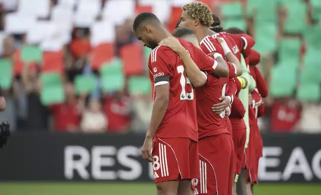 Liverpool players observe a moment of silence for the late Liverpool player Diogo Jota before the English Premier League soccer match between Liverpool and Bournemouth at Anfield stadium in Liverpool, England, Friday, Aug. 15, 2025. (AP Photo/Ian Hodgson)