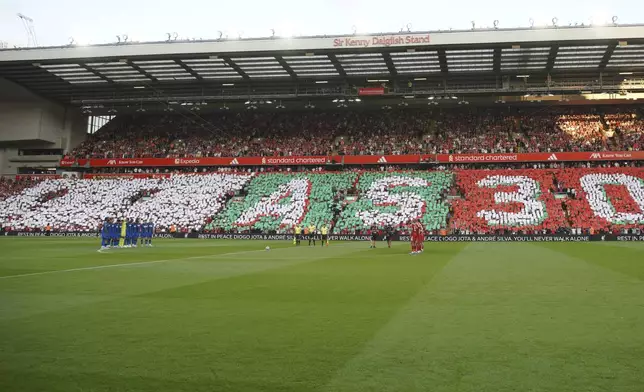 Players observe a moment of silence for the late Liverpool player Diogo Jota before the English Premier League soccer match between Liverpool and Bournemouth at Anfield stadium in Liverpool, England, Friday, Aug. 15, 2025. (AP Photo/Ian Hodgson)