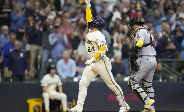 Milwaukee Brewers' William Contreras (24) reacts to hitting a home run during the third inning of a baseball game against the Arizona Diamondbacks Tuesday, Aug. 26, 2025, in Milwaukee. (AP Photo/Kayla Wolf)