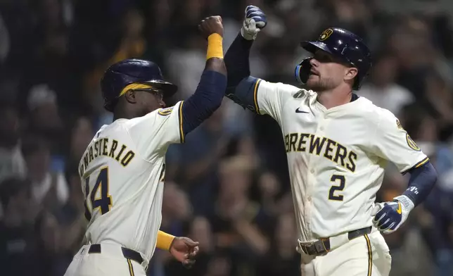 Milwaukee Brewers' Brice Turang (2) celebrates a two-run home run with Andruw Monasterio (14) during the sixth inning of a baseball game against the Arizona Diamondbacks, Tuesday, Aug. 26, 2025, in Milwaukee. (AP Photo/Kayla Wolf)