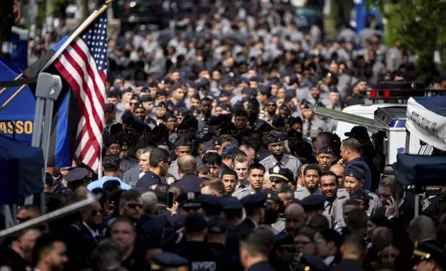 New York Police officers arrive to the Bronx to attend the funeral of Didarul Islam, the officer who was killed in a shooting in midtown, Thursday, July 31, 2025, in New York. (AP Photo/Angelina Katsanis)