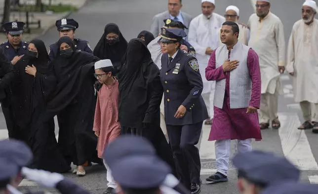 Family members of officer Didarul Islam walk behind the hearse after Islam's funeral, Thursday, July 31, 2025, in New York. (AP Photo/Angelina Katsanis)