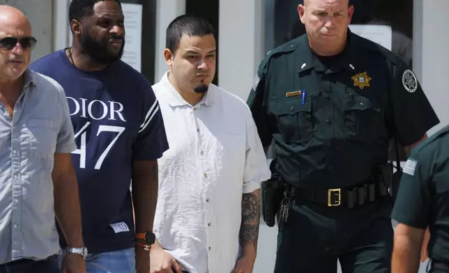 Kilmar Abrego Garcia , second right, leaves the Putnam County Jail, Friday, Aug. 22, 2025, in Cookeville, Tenn. (AP Photo/Brett Carlsen)