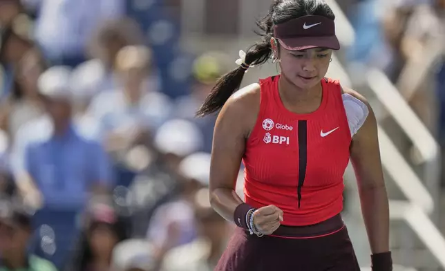 Alexandra Eala, of the Philippines, reacts after scoring a point against Clara Tauson, of Denmark, during the first round of the US Open tennis championships, Sunday, Aug. 24, 2025, in New York. (AP Photo/Seth Wenig)