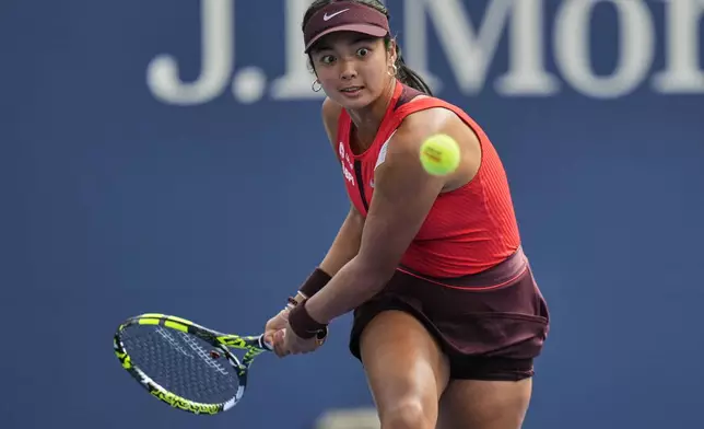 Alexandra Eala, of the Philippines, returns a shot to Clara Tauson, of Denmark, during the first round of the US Open tennis championships, Sunday, Aug. 24, 2025, in New York. (AP Photo/Seth Wenig)