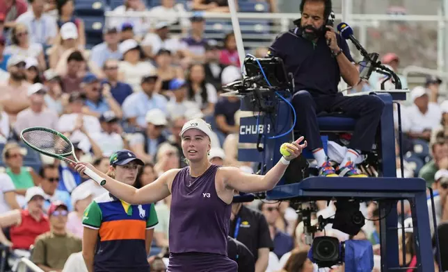 Clara Tauson, of Denmark contests a call with the chair umpire between serves against Alexandra Ella, of the Philippines, during the first round of the US Open tennis championships, Sunday, Aug. 24, 2025, in New York. (AP Photo/Seth Wenig)