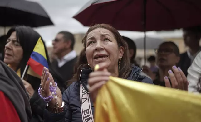 Mourners line up outside the cathedral in Bogota, Colombia, ahead of the funeral Mass for presidential hopeful and opposition Sen. Miguel Uribe, who died of gunshot wounds sustained at a political rally, Wednesday, Aug. 13, 2025. (AP Photo/Ivan Valencia)