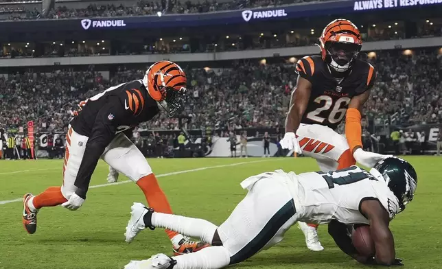 Philadelphia Eagles wide receiver Darius Cooper (41) scores a touchdown in front of Cincinnati Bengals safety Tycen Anderson (26) during the first half of an NFL preseason football game Thursday, Aug. 7, 2025, in Philadelphia. (AP Photo/Matt Slocum)