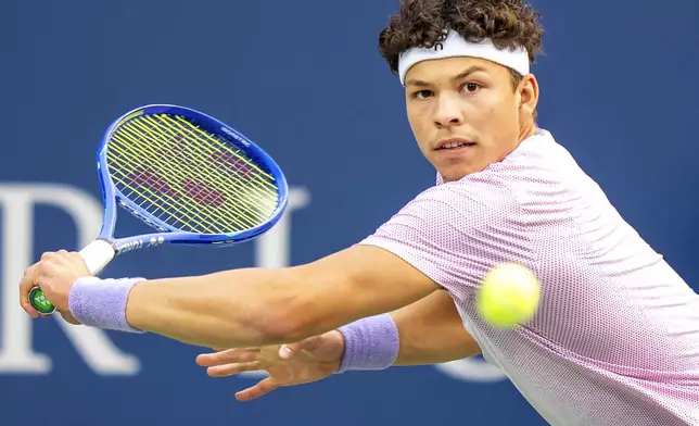 Ben Shelton of the United States, hits a backhand return to Flavio Cobolli, of Italy, during their match at the National Bank Open men's tennis tournament in Toronto, Sunday, Aug. 3, 2025. (Frank Gunn/The Canadian Press via AP)