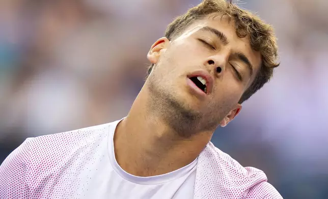 Flavio Cobolli, of Italy, reacts after getting broken by Ben Shelton, of the United States, during their match at the National Bank Open men's tennis tournament in Toronto, Sunday, Aug. 3, 2025. (Frank Gunn/The Canadian Press via AP)