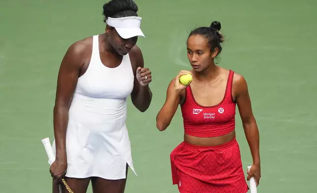 Venus Williams, of the United States, left, and Leylah Fernandez, of Canada, talk on the court during a first round women's doubles match against Lyudmyla Kichenok, of the Czech Republic and Ellen Perez, of Australia, during the U.S. Open tennis championships, Thursday, Aug. 28, 2025, in New York. (AP Photo/Yuki Iwamura)